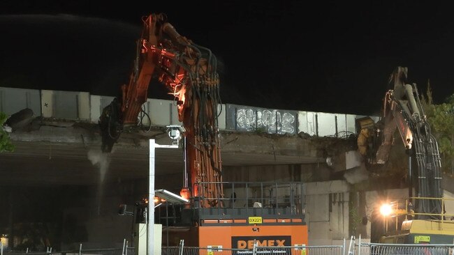 Two cranes removing concrete as old bridges are demolished as part of the $1 billion M1 upgrade from Varsity Lakes to Tugun.