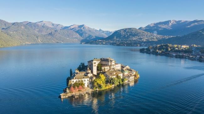 1/11Most romantic: Lake OrtaThis small, tranquil lake in the    foothills of Piedmont near the   Swiss border is encircled by thick forest and has all the romantic charm of A-list-approved Lake Como, minus the Gucci-toting tourists. Hop on a ferry for views from the island of San Giulio (also known as the Island of Silence due to its historic monastery). Back on the mainland, the medieval village of Orta San Giulio offers markets, churches and a Michelin-starred meal at Moorish hotel Villa Crespi. 