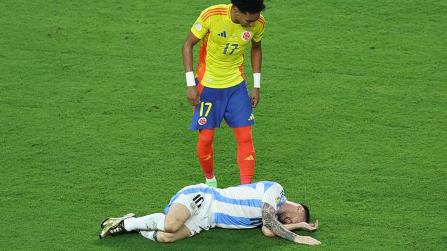 Lionel Messi of Argentina lies on the grass with an injury. Photo by Megan Briggs/Getty Images.