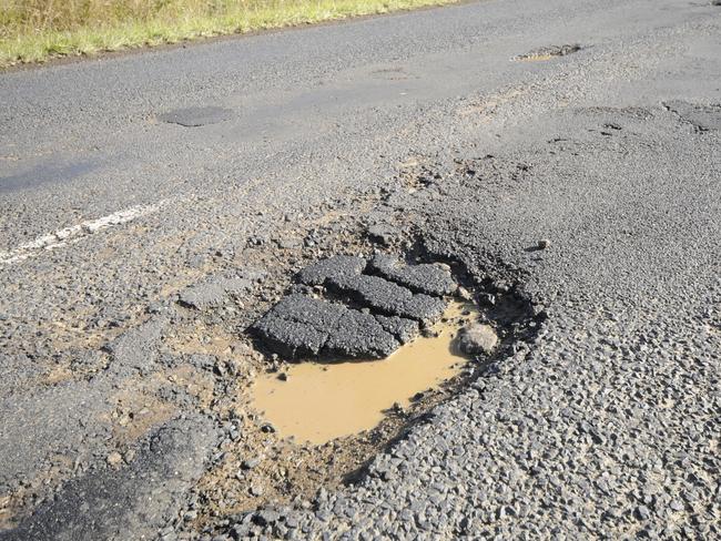 12-6-2012 Hundreds of pot holes line the Lismore to Kyogle road. Photo Doug Eaton / The Northern Star