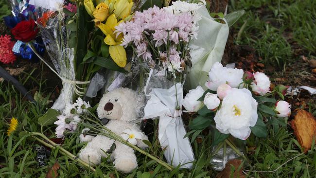 Floral tributes at the scene of a fatal traffic crash at Manoora, where an allegedly stolen Toyota Yaris left Pease Street near the Saltwater Creek bridge and crash into a tree. A 14-year-old boy was declared dead at the scene. Picture: Brendan Radke