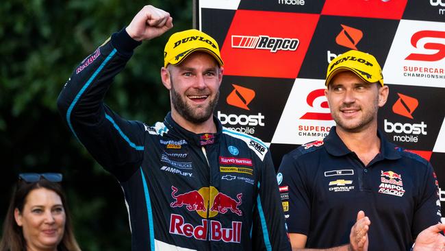 Shane van Gisbergen is congratulated on the podium.