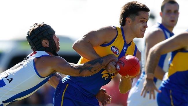 PERTH, AUSTRALIA - MARCH 01: Noah Long of the Eagles looks to handball as he gets tackled during the 2025 AAMI AFL Community Series match between West Coast Eagles and North Melbourne Kangaroos at Hands Oval on March 01, 2025 in Bunbury, Australia. (Photo by James Worsfold/Getty Images)