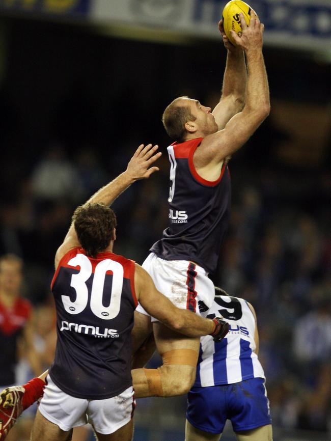 David Neitz marks over the Kangaroos’ Brent Harvey.