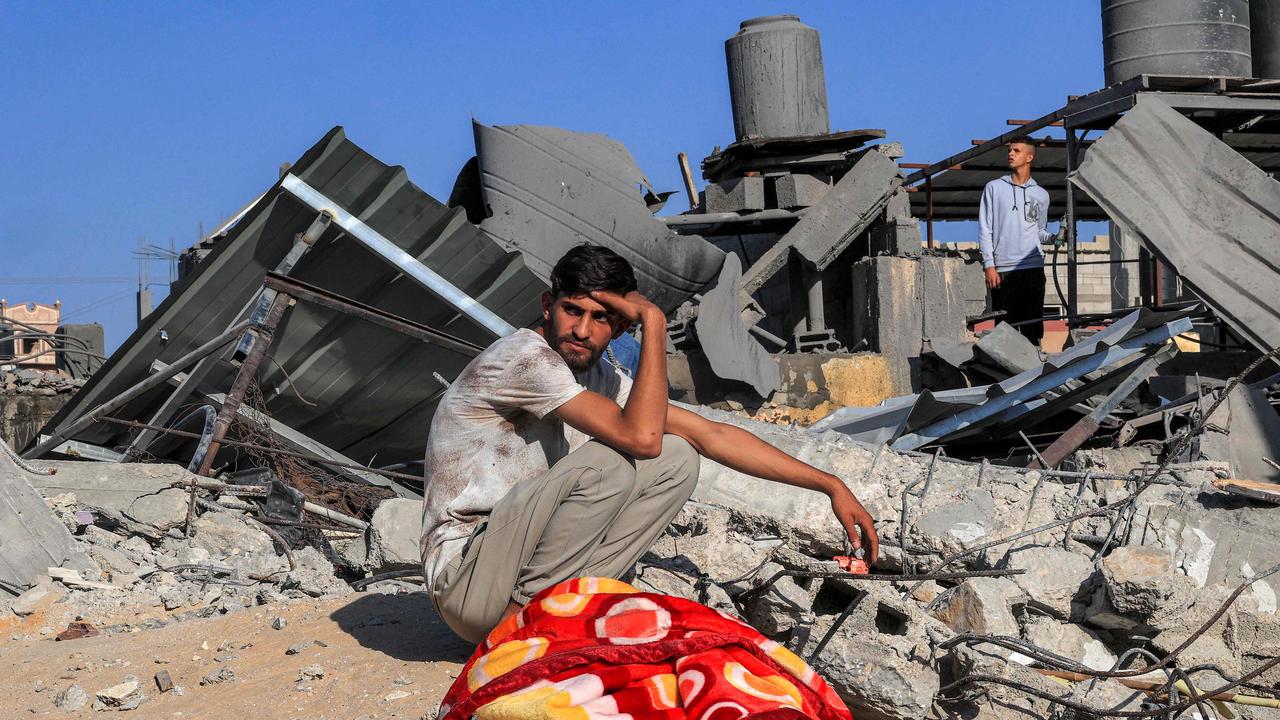 A Palestinian youth sits by the rubble of a building following an Israeli air strike in Rafah in the southern Gaza Strip. Picture: AFP