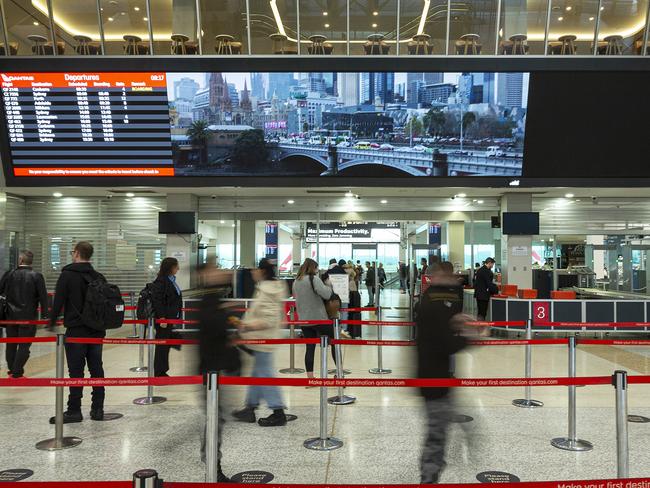 MELBOURNE, AUSTRALIA - JULY 07: Passengers wait to go through security at the Qantas departures terminal at Tullamarine Airport on July 07, 2020 in Melbourne, Australia. The NSW-Victoria border will close at 11:59pm on Tuesday evening due to a large spike in COVID-19 cases in Victoria. It is the first time in 100 years the border between the two states has been closed, and comes after Victoria recorded its highest-ever daily increase in cases, 127, since the start of the pandemic on Monday, along with the deaths of two Victorian men. From 12:01 Wednesday 8 July, NSW residents returning from Victoria will need to self isolate for 14 days. Special provisions will be in place for border communities such as Albury-Wodonga as well as freight operations and other critical services. (Photo by Daniel Pockett/Getty Images)