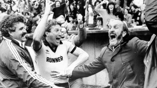 Glenelg reserves coach Steve Hywood (left), fitness coach Mark Coombe and coach John Halbert celebrate the victory over Port Adelaide.