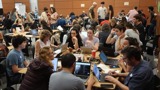 Volunteers take part in a taskforce in Tel Aviv to identify missing persons in the aftermath of the attack. Picture: AFP