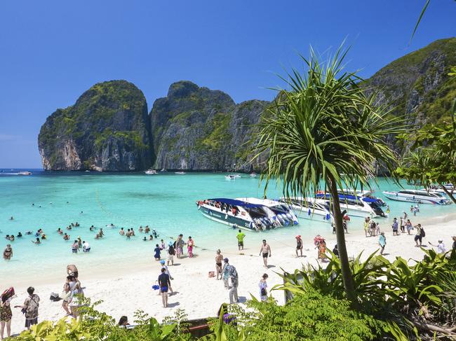 In this March 4, 2017, photo, tourists enjoy the popular Maya bay on Phi Phi island, Krabi province. Authorities have ordered the temporary closing of the beach made famous by the Leonardo DiCaprio movie "The Beach" to halt environmental damage caused by too many tourists. (AP Photo/Rajavi Omanee)