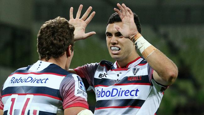 Super Rugby - Melbourne Rebels v Queensland Reds at AAMI Park , Jack Debreczeni celebrate's a try with Tom English. 3rd April 2015. Picture: Colleen Petch.