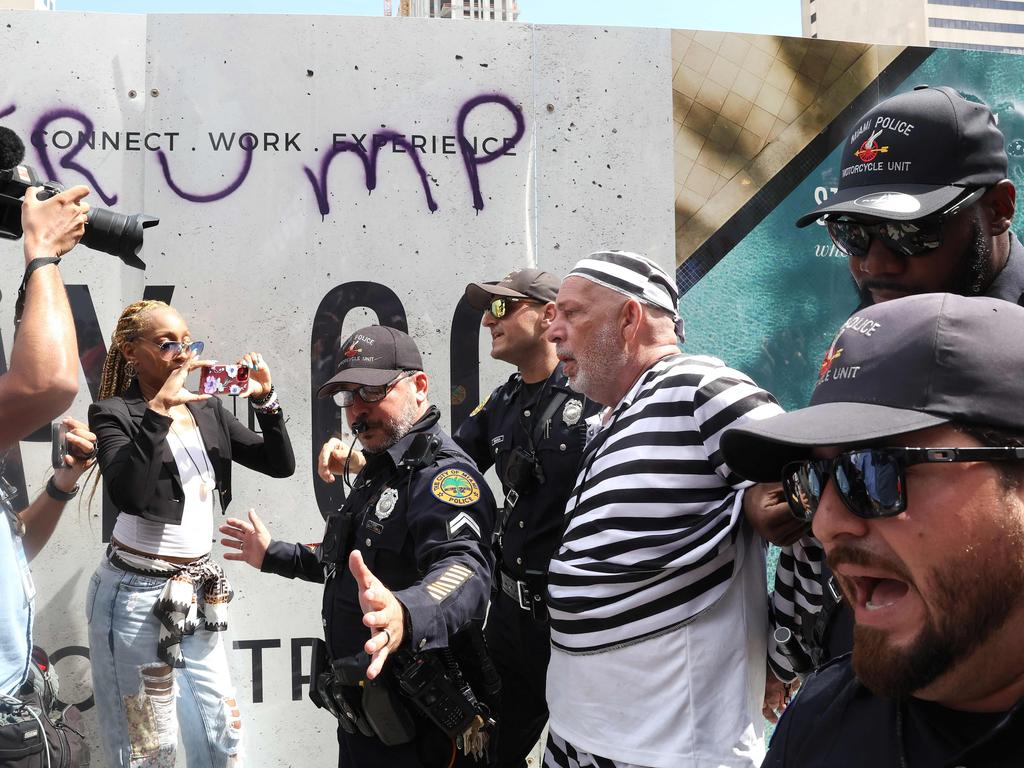 The protester, dressed in a prison jumpsuit, detained outside the Wilkie D. Ferguson Jr. United States Federal Courthouse. Picture: Getty Images North America/ Getty Images via AFP