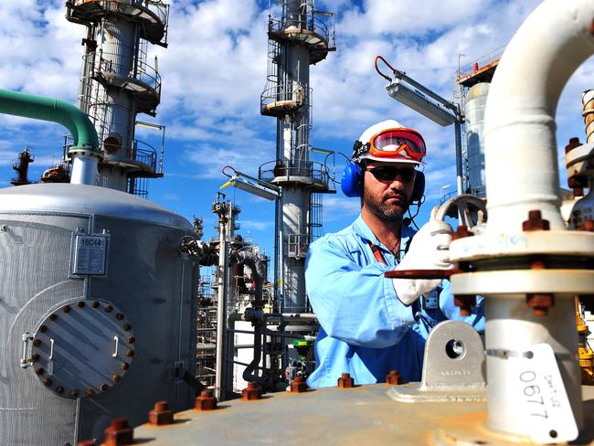 Uwe Klimmer, senior area operator, checks the diesel hydrotreater unit in the sour water plant at Caltex Australia Ltd.'s Lytton refinery in Brisbane, Australia, on Tuesday, Dec. 21, 2010. Caltex Australia is the nation's biggest oil refiner. Photographer: Eric Taylor/Bloomberg *** Local Caption *** Uwe Klimmer