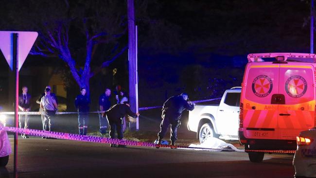 Detectives searching near the body of Fares Abounader. Picture: Steve Tyson