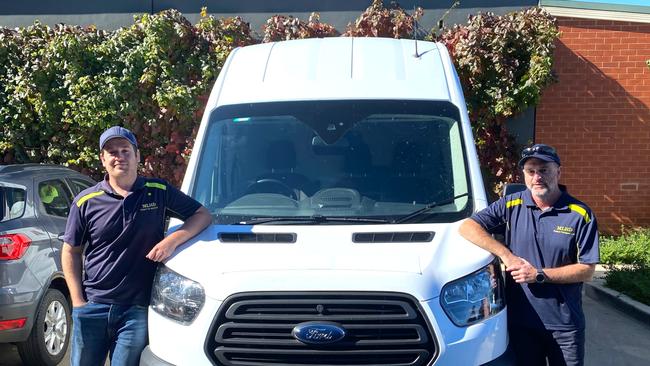 Patient Transport Officers Ben Thompson and Ian McDougall with the mobile testing clinic vehicle. Picture: MLHD