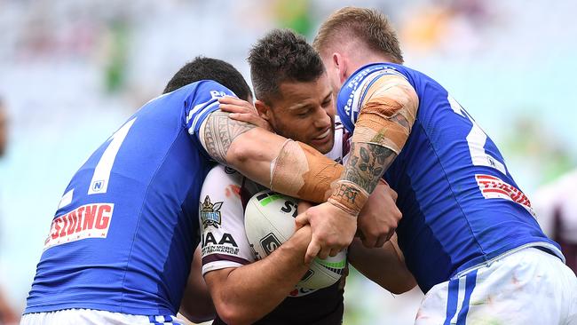 Matthew Robinson of the Bears is tackled by Wes Lolo (left) and Daniel Vasquez of the Jets. (AAP Image/Dan Himbrechts)