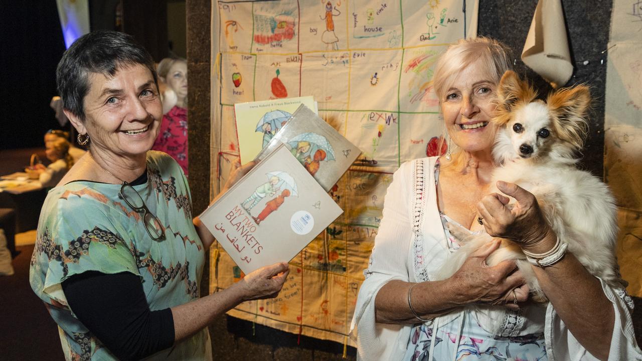 My Two Blankets author Irena Kobald (left) with Curious Arts Festival visitor Win Jones holding Sopie in the Garden of Curiosity at Empire Theatres, Saturday, April 2, 2022. Picture: Kevin Farmer