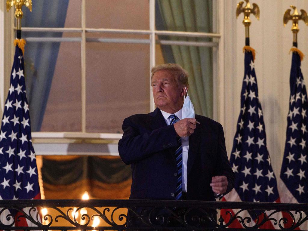 The president takes off his face mask as he arrives at the White House upon his return from Walter Reed Medical Center, where he underwent treatment for COVID-19, in Washington, DC. Picture: AFP