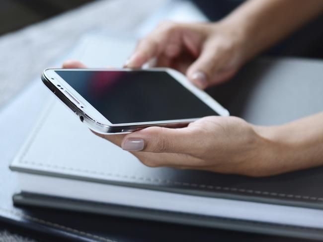 Hands of a businesswoman using a smartphone