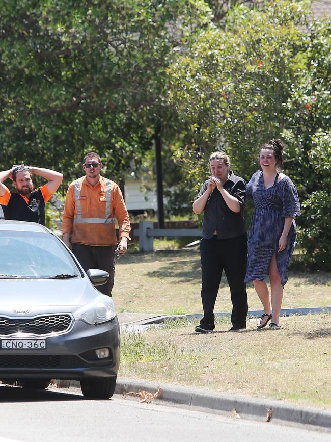 Distraught residents watch the fire take hold. Picture: Peter Lorimer.