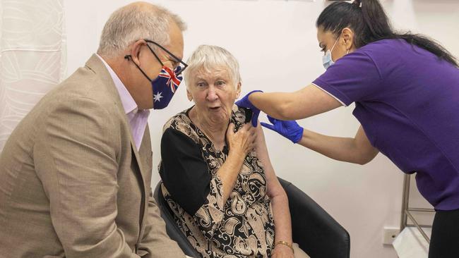 Australian Prime Minister Scott Morrison with the first vaccine recipient, Jane Malysiak as she receives her jab at Castle Hill Medical Centre. Picture: NCA NewsWire / Jenny Evans