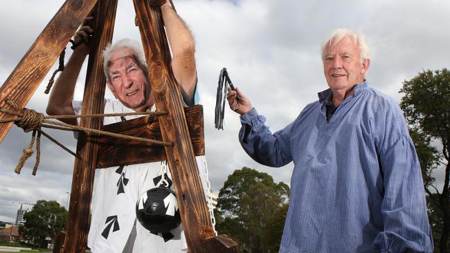 Members of the Liverpool Men's Shed John Jewell and Ralph Gardner re-enact a flogging in Bigge Park. Picture: Robert Pozo