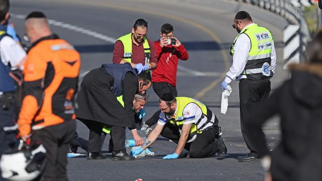 Israeli rescue teams inspect the scene of a shooting attack in Jerusalem on Thursday. Picture: AFP