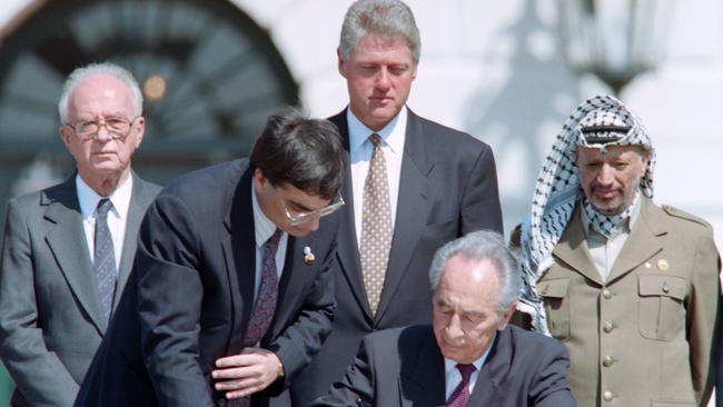 Israeli Foreign Minister Shimon Peres (C) signing the historic Israel-PLO Oslo Accords on Palestinian autonomy in the occupied territories in a ceremony at the White House in Washington, September, 1993. Picture: AFP Photo