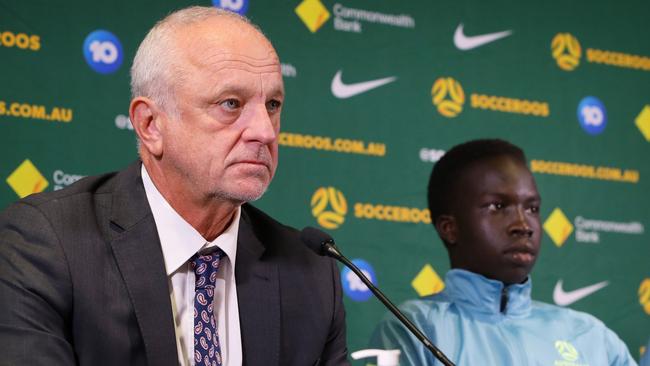 SYDNEY, AUSTRALIA - SEPTEMBER 14: Graham Arnold (L) is joined by players Garang Kuol and Jason Cummings during a Socceroos squad announcement and press conference at Dexus Place on September 14, 2022 in Sydney, Australia. (Photo by Lisa Maree Williams/Getty Images)