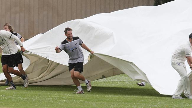 Cricket GCA1: North Geelong v Lara. Rain delay putting the covers on Picture: Mark Wilson