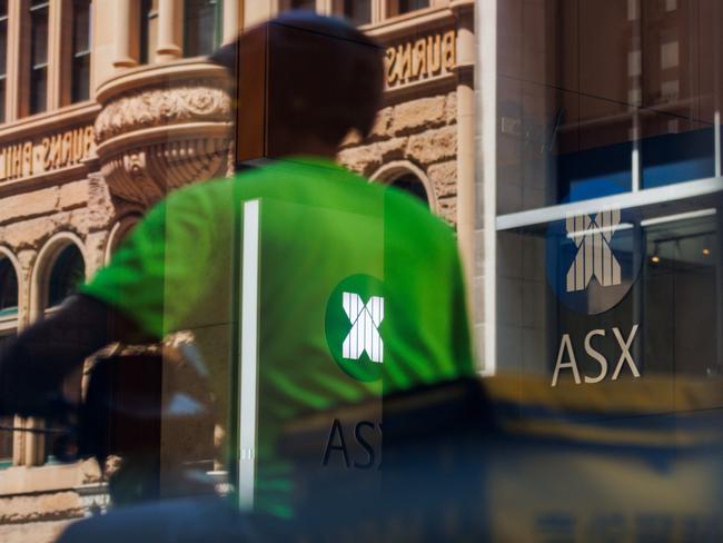 SYDNEY, AUSTRALIA - NewsWire Photos, October 29 2024. GENERIC. Stocks. Finance. Economy. A food delivery rider passes the Australian Stock Exchange, ASX, on Bridge Street. Picture: NewsWire / Max Mason-Hubers