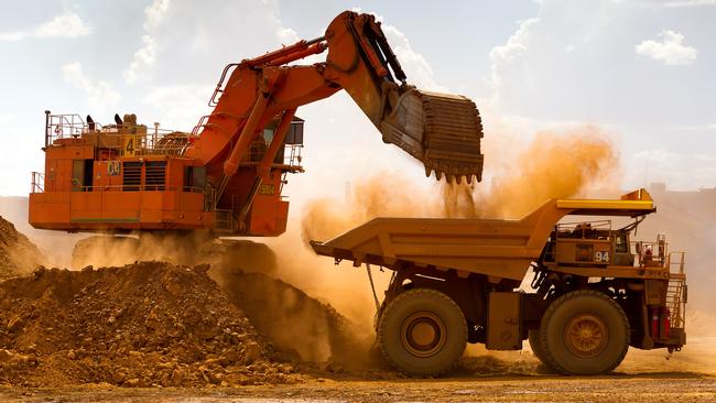 A haul truck is loaded by a digger with material from the pit at Rio Tinto Group's West Angelas iron ore mine in Pilbara. Picture: Ian Waldie/Getty Images