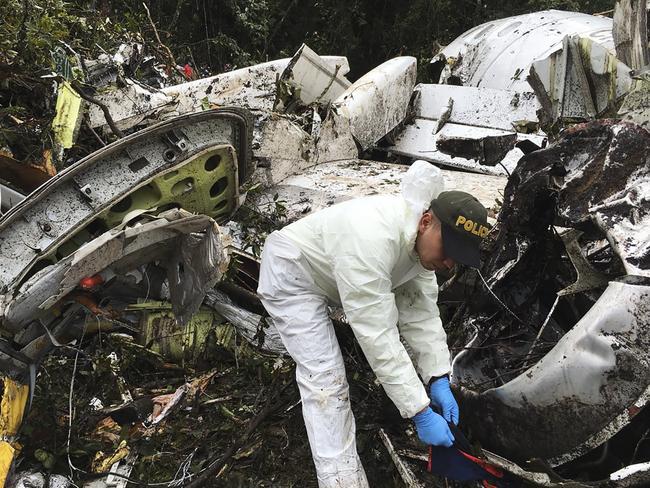 A police officer works at the wreckage site of a chartered airplane that crashed in La Union, a mountainous area outside Medellin, Colombia, Tuesday, Nov. 29, 2016. The plane was carrying the Brazilian first division soccer club Chapecoense team that was on it's way for a Copa Sudamericana final match against Colombia's Atletico Nacional. (Photo/Colombia National Police via AP)