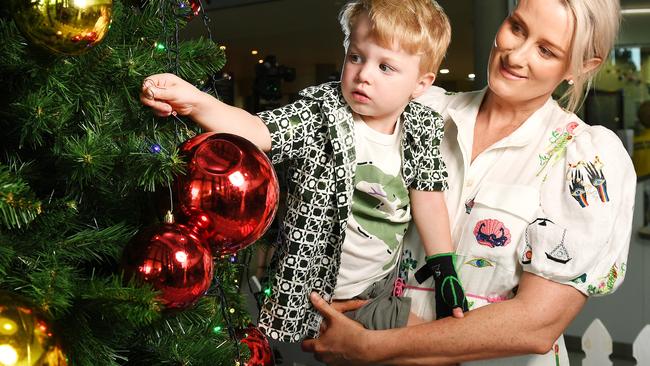 Kimberley McNamara with her son Freddy, 2, help to welcome the Christmas cheer at Townsville University Hospital. Picture: Shae Beplate.