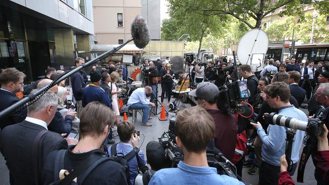 The media surrounds a victim watching the livestream. Picture: Getty Images.