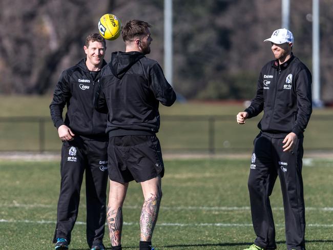 Dane Swan of the Magpies completes a handball drill with assistant coaches Scott Burns and Matthew Lappin during a Collingwood Football Club training at session at Olympic Park Melbourne, on Friday 15th August, 2014. Picture: Mark Dadswell