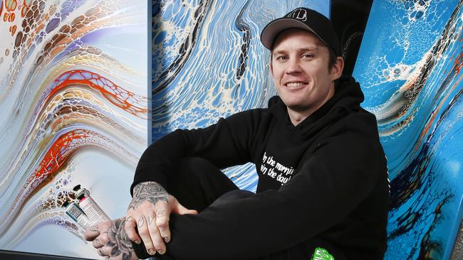 Dayne surrounded by some of his works art at his Health of Mind Art studio. Picture: David Caird