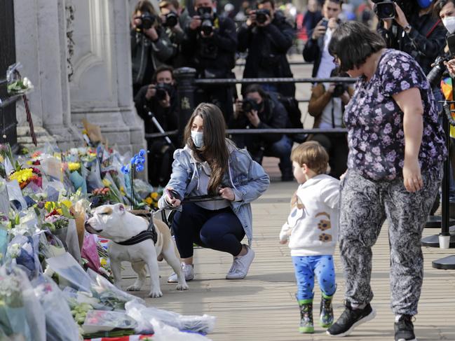 People lay flowers outside of Buckingham Palace after the death of Prince Philip. Picture: Getty Images