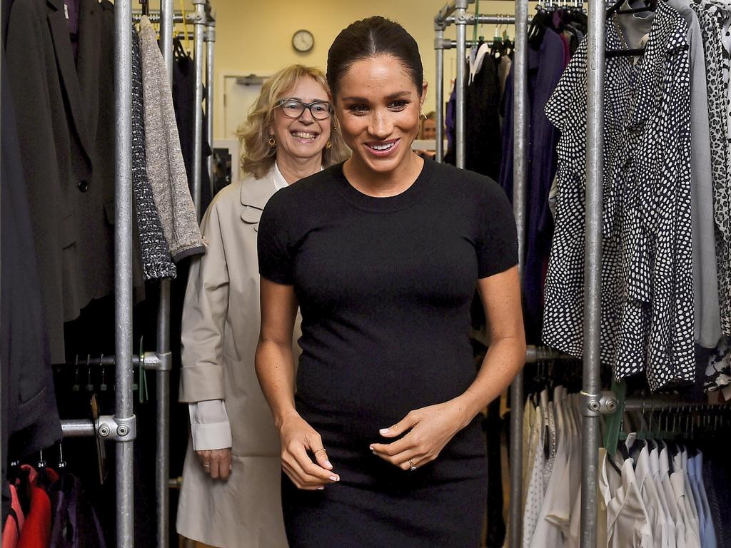 Meghan is accompanied by Juliet Hughes-Hallett, as they walk past racks of clothes at the Smart Works charity career centre in West London. Picture: AP