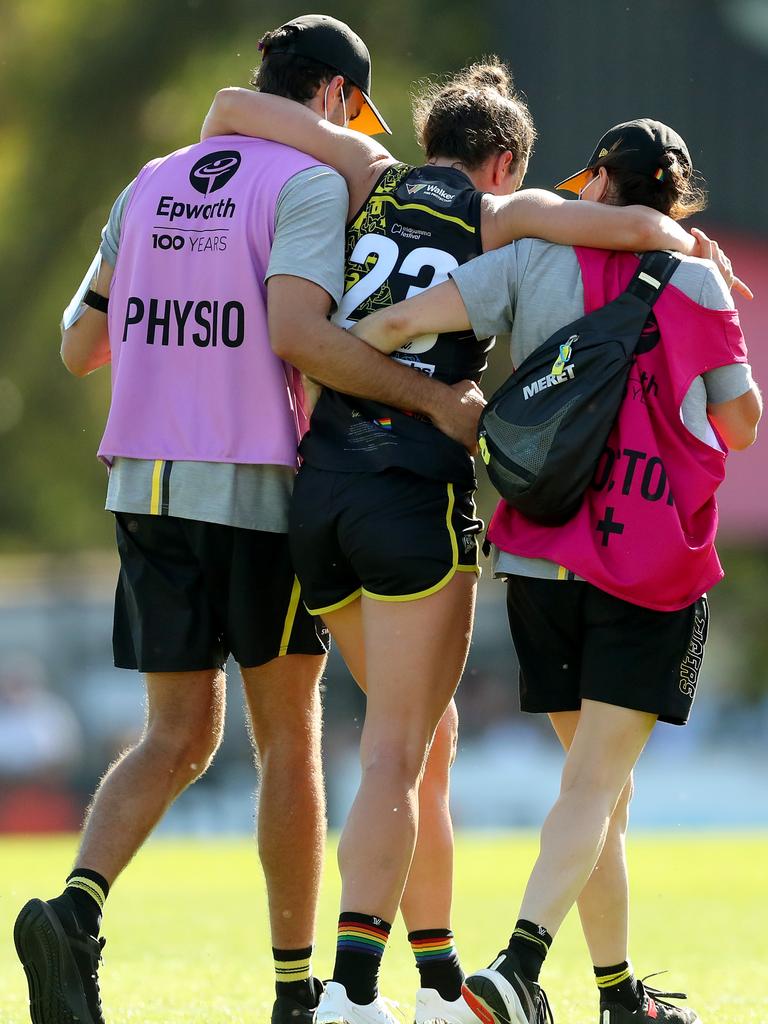 Harriet Cordner is helped from the field.