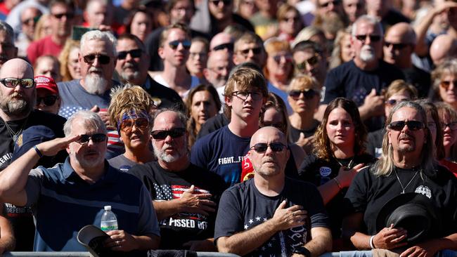 Attendees stand for the national anthem during the rally. Picture: Kevin Dietsch / Getty Images / AFP