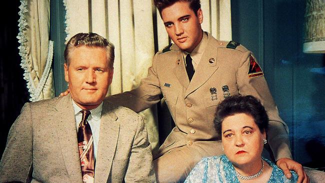 Elvis Presley in uniform with father Vernon and mother Gladys.