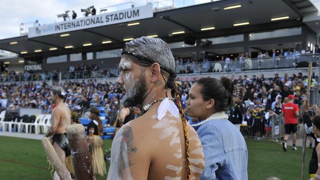 Jesse Shilling from the Wajaar Ngaarlu dance troupe forms part of Shaun Johnson's guard of honour. Photo: Tim Jarrett