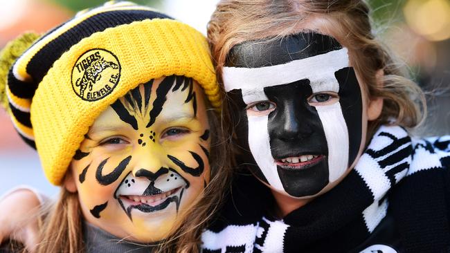 Evie White,5 and Millie Lokan ,5, supporting their dads Port Adelaide coach Matthew Lokan and Glenelg player Jesse White during the Rundle Mall Grand Final Eve Presentations. Picture: AAP Image/Mark Brake