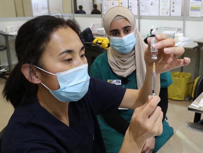 Staff prepare COVID-19 vaccinations at Melbourne Showgrounds yesterday. Picture: NCA NewsWire / David Crosling