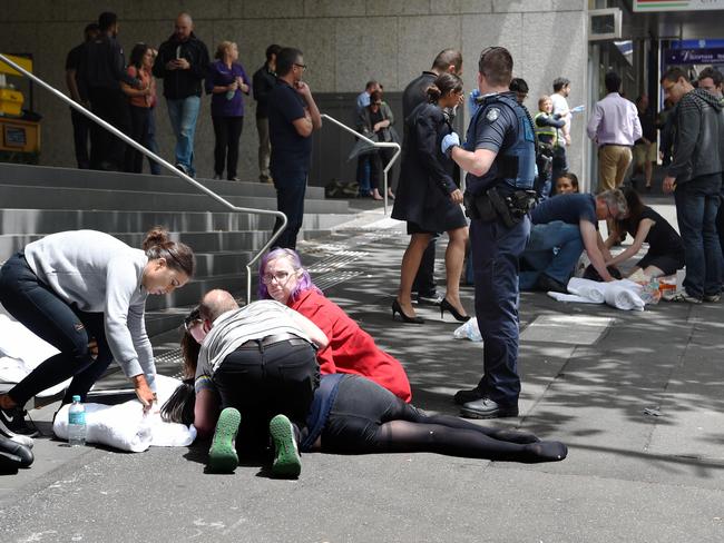 Shoppers rush to the aid of those hit by the car. Picture: Tony Gough