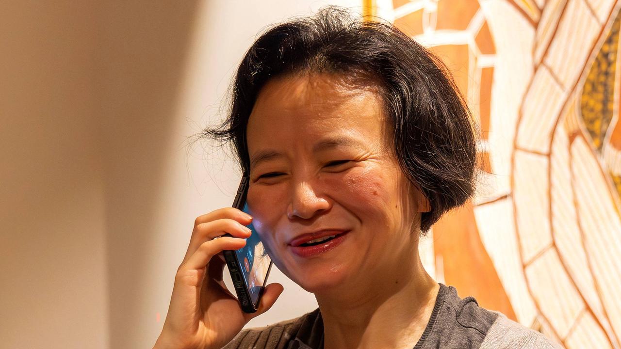 Australian journalist Cheng Lei speaking on a phone upon her arrival at the airport in Melbourne after she was held in HCina. Picture: AFP