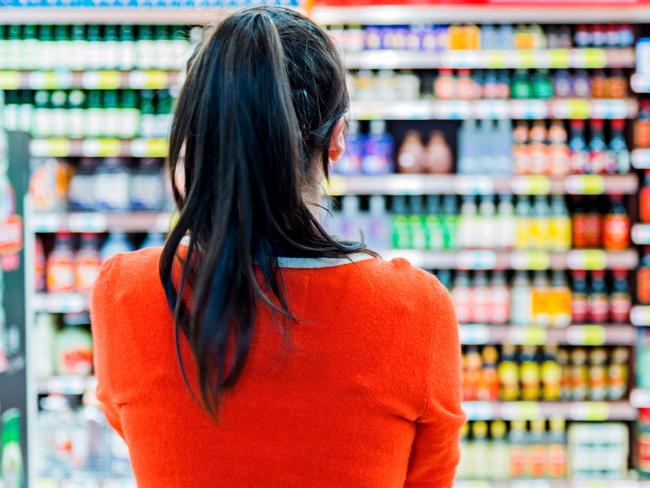 Rear view of woman doing shopping in a supermarket.