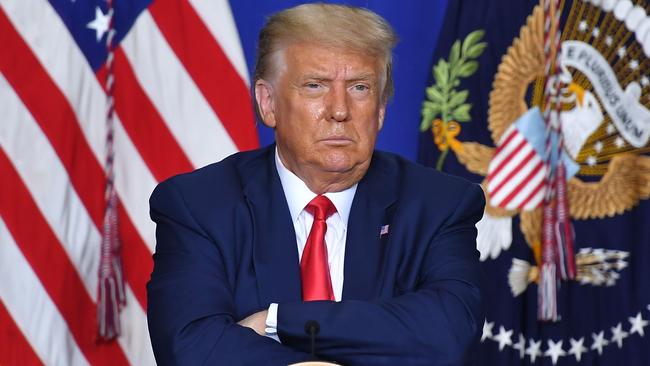 US President Donald Trump listens to officials during a roundtable discussion on community safety, at Mary D. Bradford High School in in Kenosha, Wisconsin on September 1, 2020. - Trump said Tuesday on a visit to protest-hit Kenosha, Wisconsin that recent anti-police demonstrations in the city were acts of "domestic terror" committed by violent mobs. "These are not acts of peaceful protest but really domestic terror," Trump said, describing multiple nights of angry demonstrations last week after a white police officer in Kenosha shot a black man in the back at close range. (Photo by MANDEL NGAN / AFP)