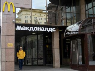 A man walks past a closed McDonald's restaurant in Moscow on May 16, 2022. - American fast-food giant McDonald's will exit the Russian market and sell its business in the increasingly isolated country, the company said May 16, 2022. In a statement McDonald's said: "After more than 30 years of operations in the country, McDonald's Corporation announced it will exit the Russian market and has initiated a process to sell its Russian business. Many Western businesses have pulled out of Russia since its invasion of Ukraine in February. (Photo by Natalia KOLESNIKOVA / AFP)