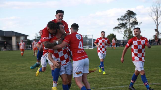 Newcastle Croatia FC players celebrate after scoring a goal in their 2022 Zone League 3 grand final win at Kurraka Oval, Fletcher. Pic: Newcastle Croatia FC.